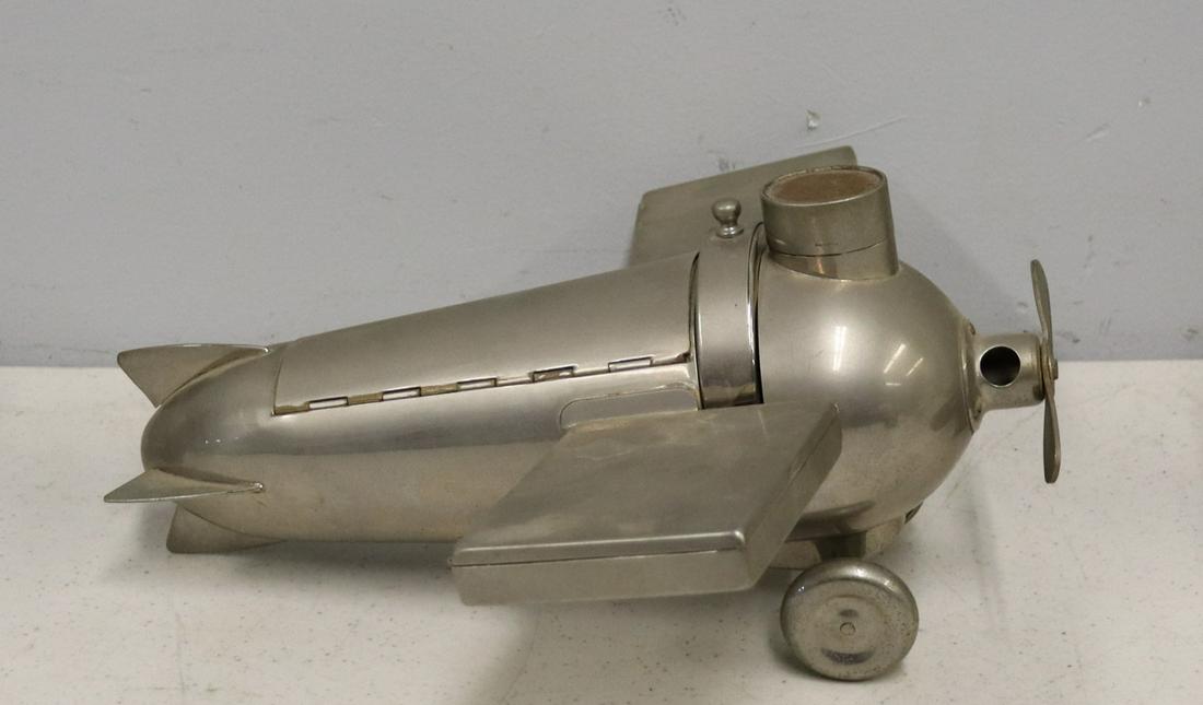 Deco Nickel Plated Aeroplane Smokers Companion: J. A. Henckels Design Deco Nickel Plated Aeroplane Smokers Companion. The nickel plated brass deco airplane is designed with a cigar cutter in the propeller with catch tray in the wheels, match holder