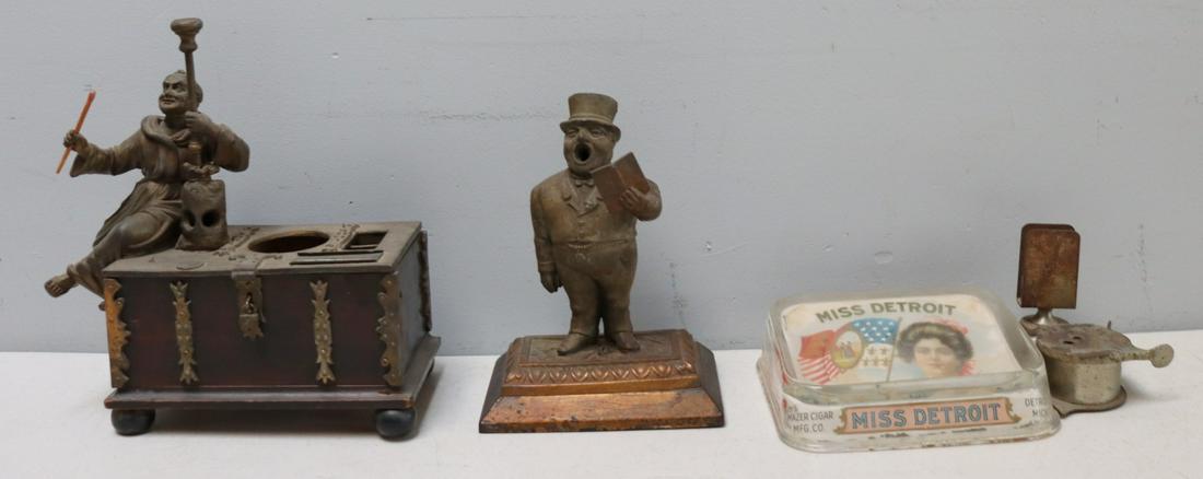 Monk On Box Cigar Cutter, Whistling Man Cutter: And Miss Detroit Glass Ashtray Cutter. From the estate of Jerry Terranova, author of "Antique Cigar Cutters & Lighters" and "Great Cigar Stuff for Collectors". Ashtray (10" x6"), whistling man (8" x 6