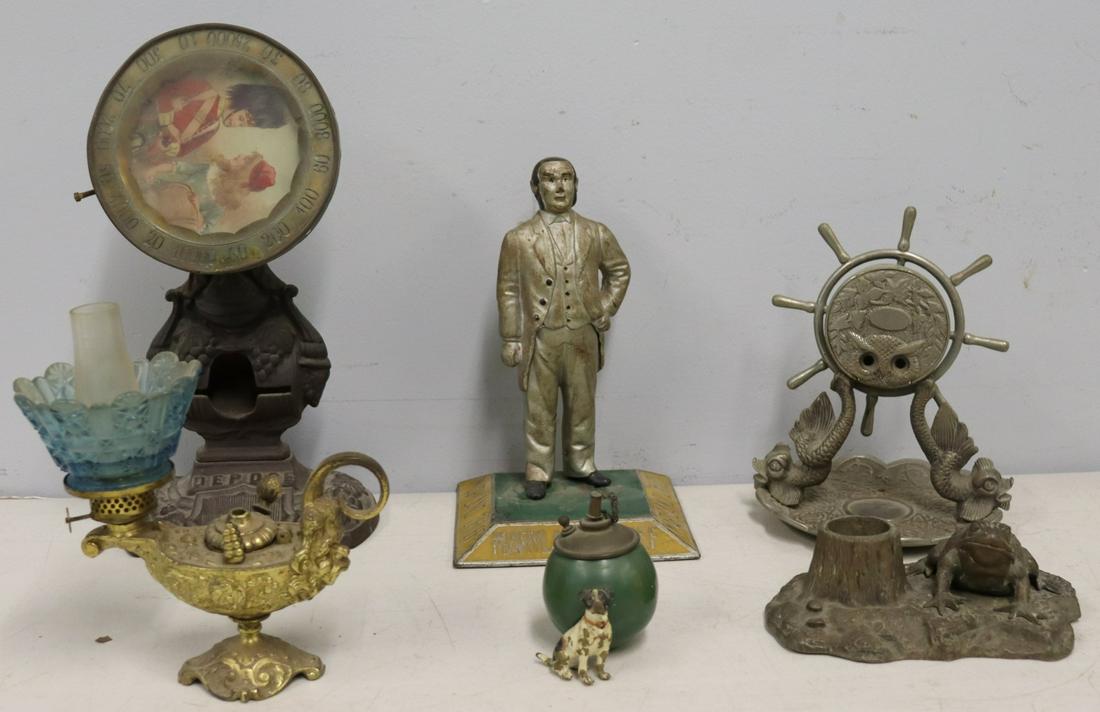 Lot Of Assorted Antique Cigar Collectibles .: Figure (12" x 6"), Depose (12"), ships wheel (8" x 6"), dog and ball (4"), oil lamp and a Frog (6"). From the estate of Jerry Terranova, author of "Antique Cigar Cutters & Lighters" and "Great Cigar S
