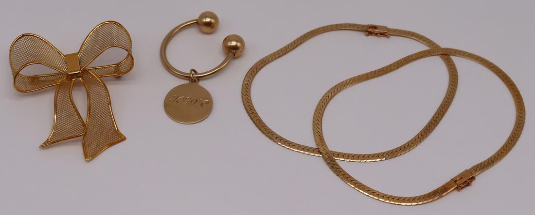 JEWELRY. Assorted 18kt and 14kt Gold.: Includes an Italian 18kt yellow gold bow form brooch, stamped verso, "Italy K18"; a monogrammed Tiffany & Co. key ring; and (2) 14kt yellow gold herringbone chain bracelets. Total approx