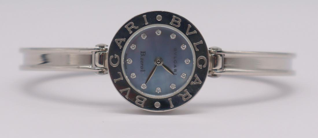 JEWELRY. Bvlgari B.Zero1 Stainless Watch.: Bvlgari B.Zero1 stainless watch with blue mother of pearl watch face and diamond markers. Bvlgari stainless hinged watch band inscribed, "Bvlgari" multiple times to edges. Underside of watch backing i