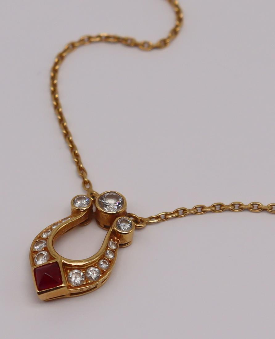 JEWELRY. Cartier 18kt Diamond and Ruby Pendant.: Cartier Paris 18kt yellow gold lyre form pendant inlaid with round brilliant cut and single cut diamonds, and a single pyramid form ruby cabochon. Ruby measures approx. 3.0mm x 3.0mm; largest bezel se