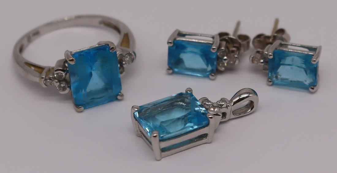 JEWELRY. 14kt Gold, Diamond and Colored Gem Suite.: Signed 14kt white gold jewelry suite comprised of a pendant, ring, and pair of earrings. 14kt white gold ring with central blue faceted gem measuring approx. 10.0mm x 8.0mm flanked by trefoils of diam