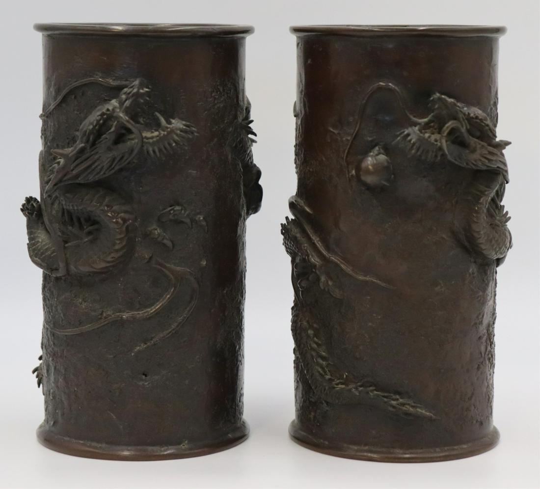 Pair of Japanese Meiji Bronze Cylindrical Vases.: With beautifully detailed depictions of dragons grasping a single pearl. From a Stamford, CT estate. Dimensions: vases measure approx. 5.5" w x 4.375" d x 8.375" h.