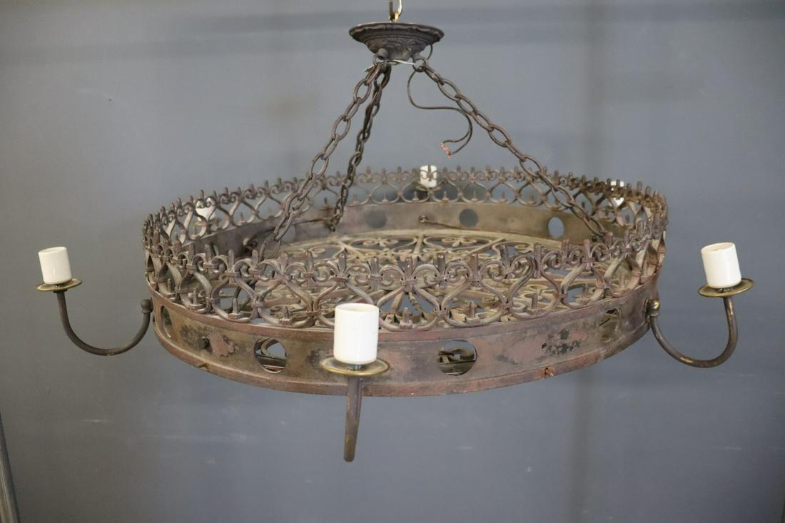 Wrought Iron Wheel Form Chandelier: 6 arms with single light on end. From a Scarsdale NY Estate. Dimensions: 30" D Condition: scuffs and scratched and wear. has not been tested all lighting sold as is working or non working.