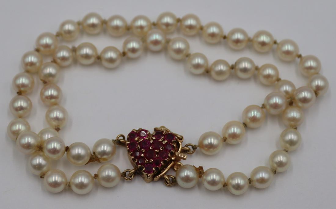 JEWELRY. 14kt Gold, Pearl and Colored Gem: Bracelet. Double strand pearl bracelet with a 14kt yellow gold heart form closure set with (14) round faceted colored gems. Pearls measure approx. 5.0mm each. Clasp is stamped, "14K". Total 