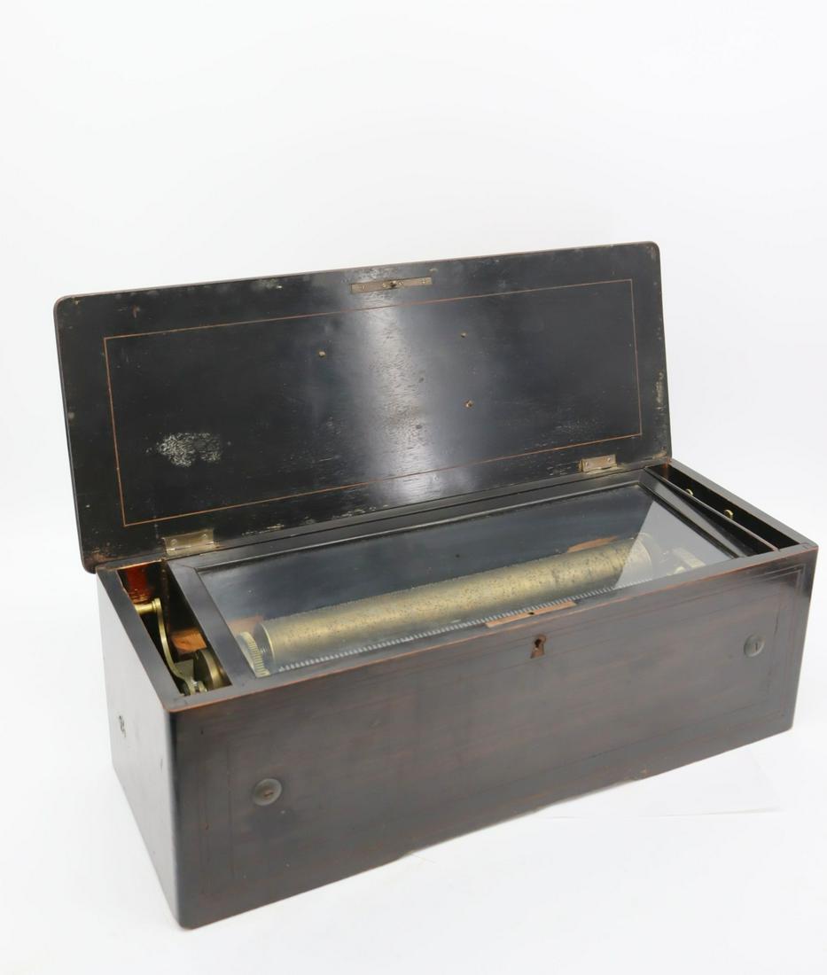 A Large B. A. Bremond Cylinder Music Box: An 80 pin (15 1/8") cylinder music box. There is one broken tooth on the comb. Box functions (it is very loud) and winds and stops. - Dimensions: 8.5" x 9" x 23.75"