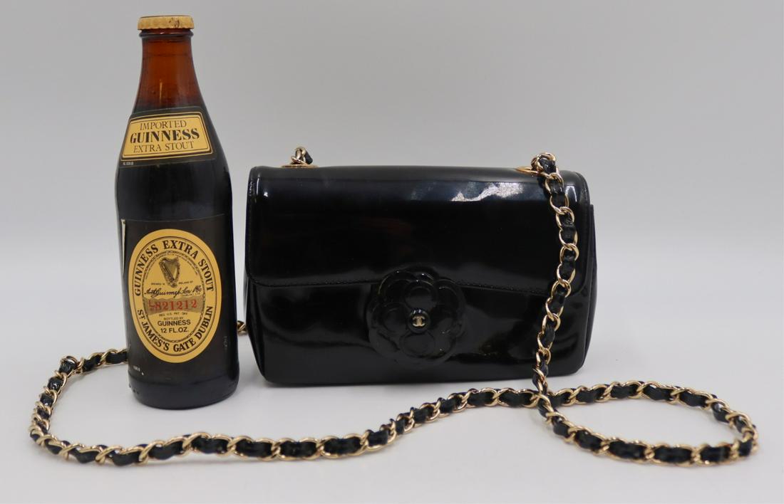 COUTURE. Chanel Camellia Patent Leather Flap Bag.: With floral form closure and gold tone chain and leather strap. Interior sticker with no. 7705085 signifying a production year of 2002-2003. From a Riverdale, NY estate. Dimensions: purse measures app