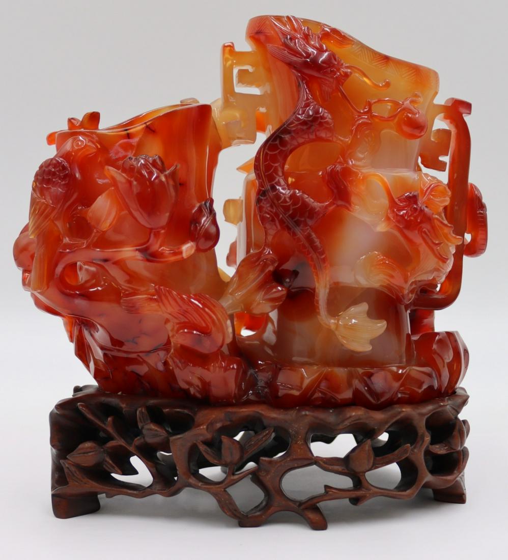 Carved Carnelian Double Urn with Birds, Flowers,: Bamboo and Dragons. On fitted carved wood base. Total approx. weight is 2252.4 grams (gross) excluding base. From the estate of a world traveler and gemologist. Dimensions: urns measure approx. 8"
