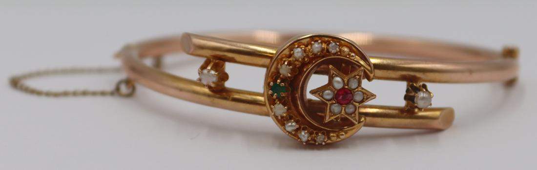 JEWELRY. 14kt Gold Hinged Bracelet with Colored: Gems and Pearls. 14kt gold hinged bypass form bracelet with central crescent moon and star inlaid with seed pearls and colored gems; flanked by (2) prong-set pearl accents. Apparently unmarked. With s