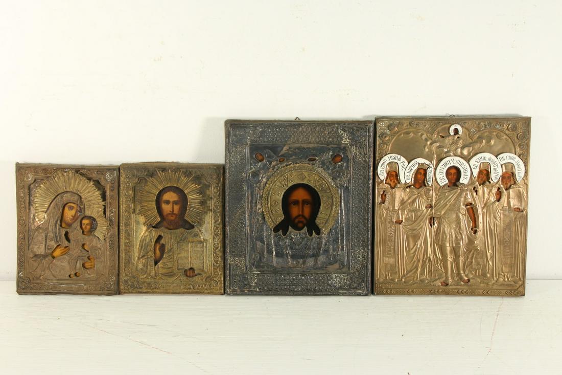 Four Russian Antique Icons .: 3 gilt metal clad and 1 with enamel work and the other well chased and possibly silver . From a Brooklyn NY estate .Dimensions ranging from 9" high x 7" wide to 12" high x 10" wide