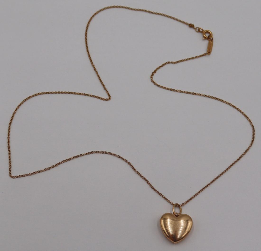 JEWELRY. Tiffany & Co. 18kt Gold Locket and Chain.: Includes a signed Tiffany & Co. 18kt yellow gold heart form locket - inscribed verso, "© Tiffany & Co AU750 Italy". Locket is suspended from a signed Tiffany & Co. 18kt yell
