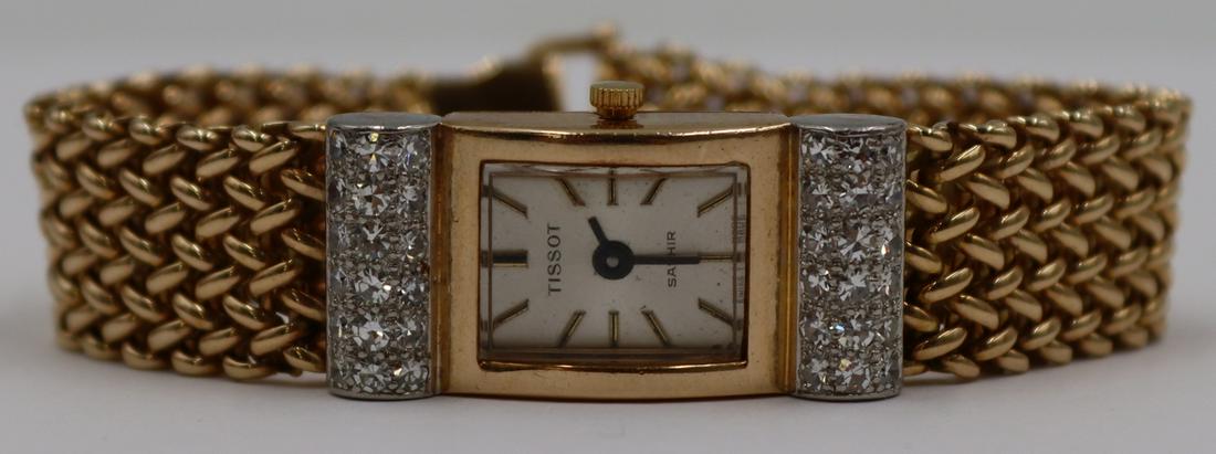 JEWELRY. Tissot Sapphir 14kt Gold & Diamond Watch: Ladies Tissot Sapphir 14kt yellow watch with pave diamond inlaid 14kt white gold barrel form terminals flanking the watch face. Stamped, "14k" to closure. With a Ronda Swiss quartz movement,