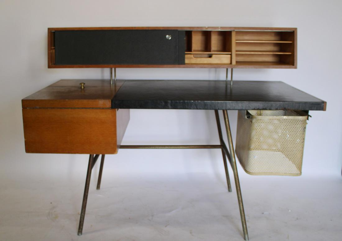 George Nelson & Associates Home Office Desk.: Model 4658.USA, 1946 walnut, chrome-plated steel, leather, perforated aluminum. Desk features flip-top storage and two doors concealing five fixed shelves. From an East 79th St NYC estate. - Dimension