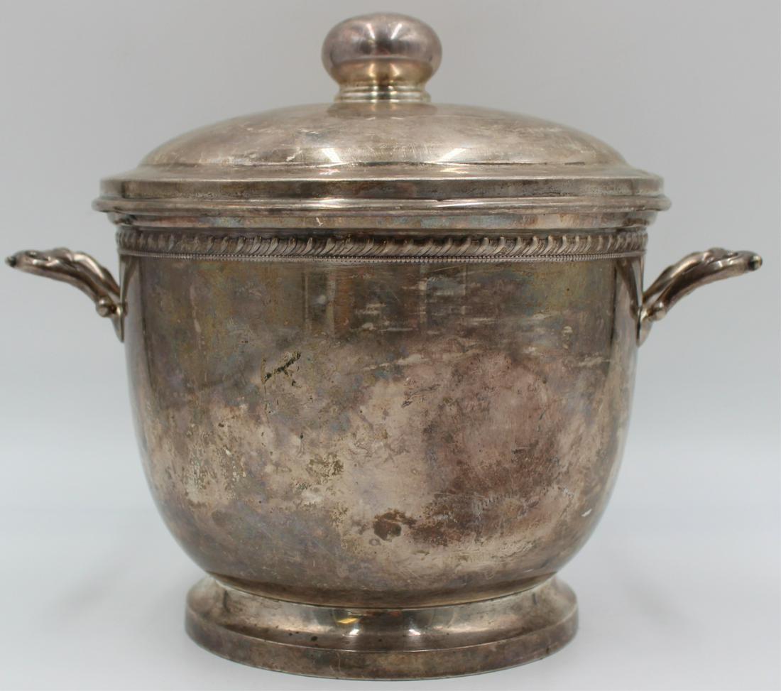 STERLING. Redlich & Co. for Cartier Sterling Ice: Bucket. A Redlich & Co. for Cartier sterling footed ice bucket with two side handles. Stamped, "Cartier Sterling 90" with a pictorial makers mark of Redlich & Co.; lid stamped, "