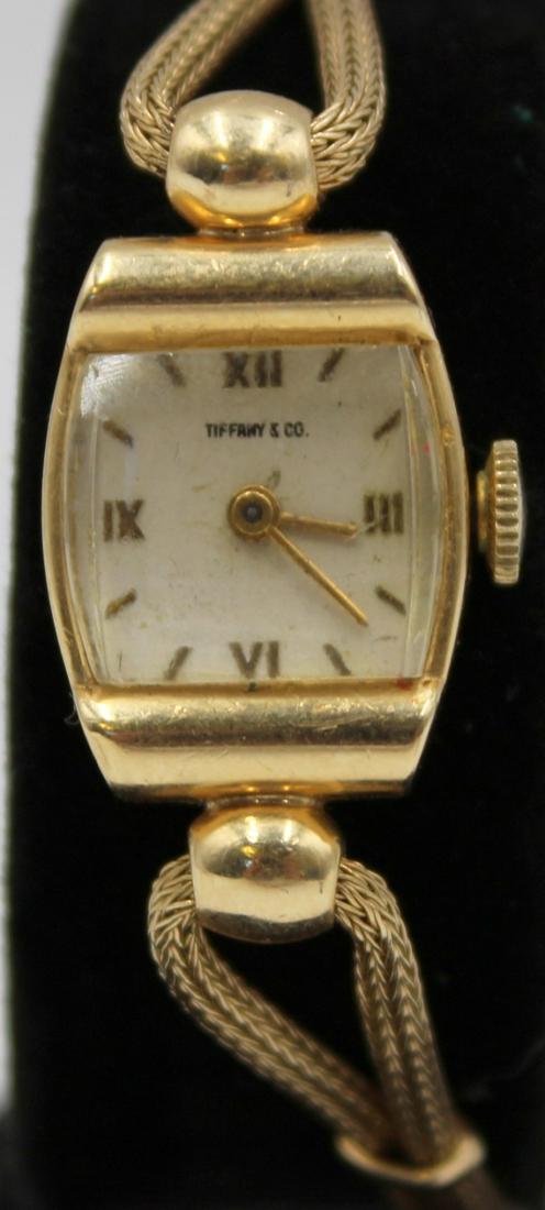 JEWELRY. Lady's Tiffany & Co. Concord 14Kt Gold: Watch. A lady's Tiffany & Co. Concord 14kt yellow gold mechanical watch. This watch features a 14mm (excluding crown) signed Concord 14kt yellow gold tonneau watch case, glass crystal, signed Tiff