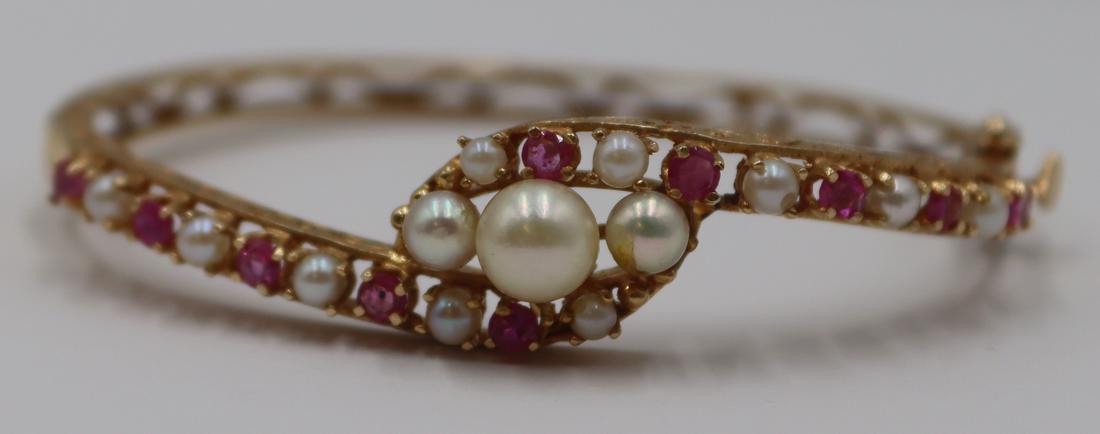 JEWELRY. 14kt Gold, Pearl, and Colored Gem: Bracelet. Vintage 14kt yellow gold bypass style bracelet decorated with (13) pearls and (10) colored gems. Total approx. weight is 9.3 dwt (gross). From a Fairfield, CT estate. Dimensions: interior di
