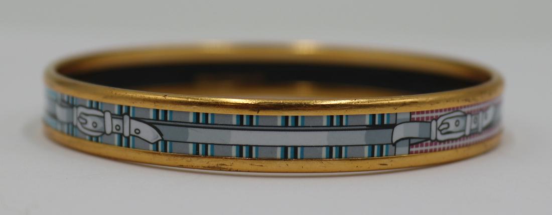 JEWELRY. Hermes Enamel Bangle Bracelet.: Signed Hermes enamel bangle bracelet with buckle decoration. Interior of bracelet inscribed, "Hermes Paris Made in France +N". From a Tuckahoe, NY estate. Dimensions: bracelet measures appro