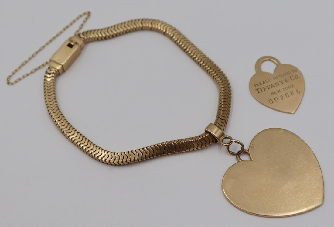 JEWELRY. 14kt Gold Bracelet & Tiffany & Co: Includes a signed Forstner 14kt yellow gold snake bracelet - signed, "Forstner 14kt". Bracelet is suspending an oversized Tiffany & Co. 14kt yellow gold heart charm. Accompanied by a sec