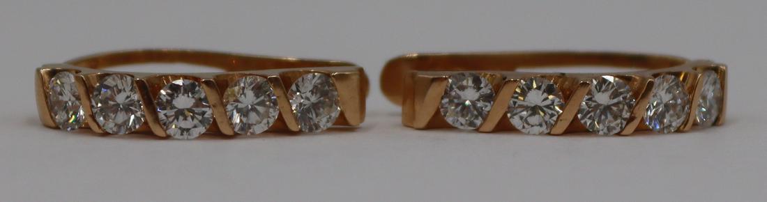 JEWELRY. 18kt Gold and approx. 1.5ct Diamond: Earrings. 18kt yellow gold hoop earrings with (10) prong-set round brilliant cut diamonds measuring approx. 3.5mm each. Total approx. diamond weight is 1.5cttw. Stamped, "18K". Total approx.