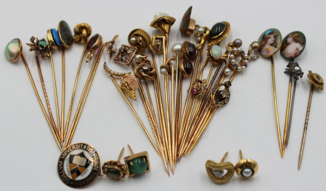 JEWELRY. (38) Assorted Gold Stickpins and Tie: Tacks. (38) assorted 9kt, 10kt, 14kt and 18kt gold stick pins and tie tacks. Including (1) 9kt gold stickpin; (7) 10kt gold stick pins with assorted colored gems and pearls; (22) 14kt gold stick pins 