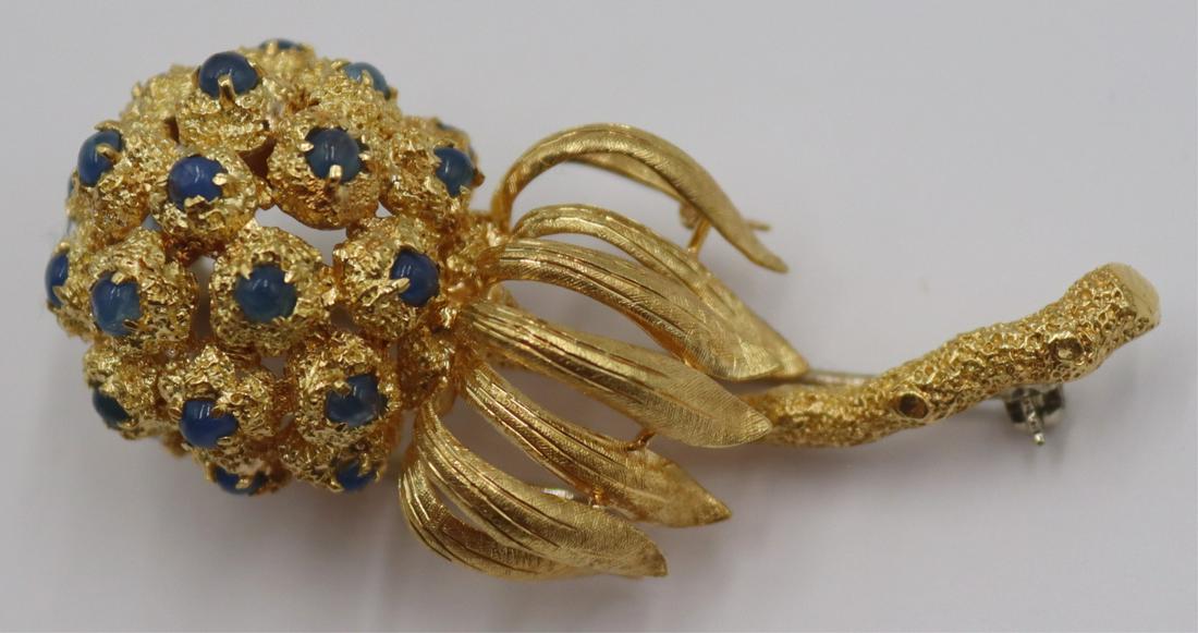 JEWELRY. Italian 18kt Gold and Colored Gem Brooch.: Italian 18kt yellow gold floral form brooch inlaid with (21) blue colored gem cabochons. Stamped, "18K Italy". Total approx. weight is 13.0 dwt (gross). From a Long Island, NY estate. Dimens