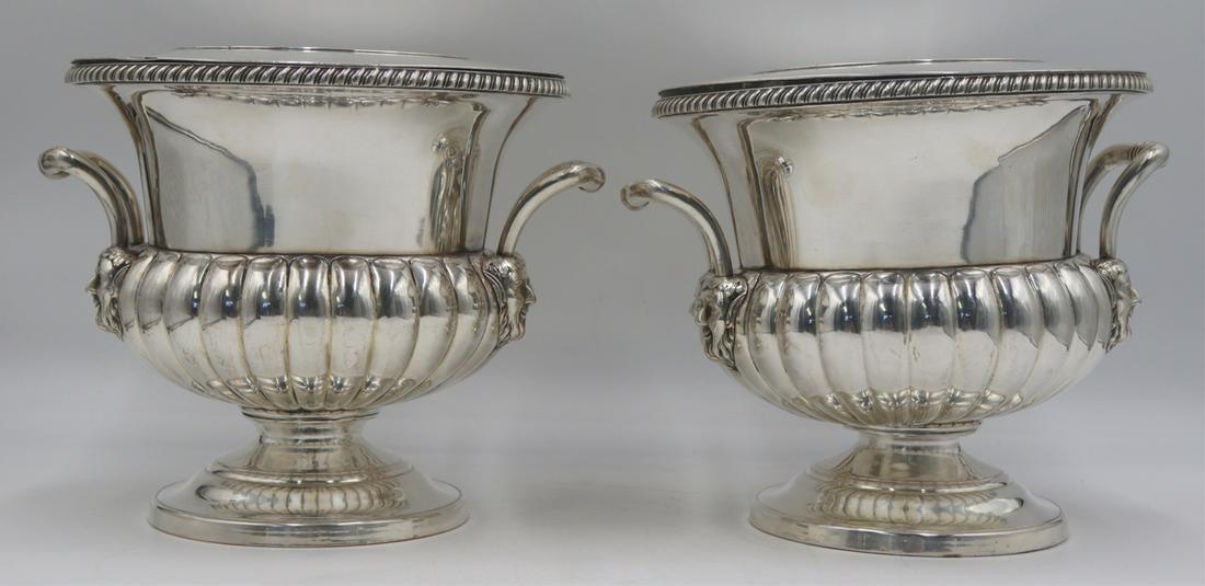 SILVERPLATE. Pair of Christofle Silverplate Wine: Coolers or Champagne Buckets. Pair of signed Christofle silverplate wine coolers or champagne buckets with lobed design to body, plain circular bases, and handles terminating in satyr heads. Stamped,