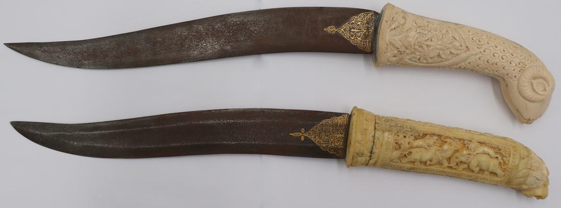 (2) Indo Persian Style Pesh-kabz Daggers.: Including an Indo Persian Style decorative Pesh-kabz dagger with an elaborately carved bone figural rams head handle with a floriated motif and a wootz steel style blade with damascening style embelli