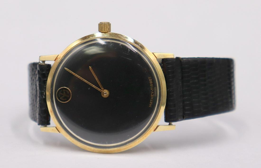 JEWELRY. Men's Mathey-Tissot 14kt gold Watch.: A vintage men's Mathey-Tissot 14kt gold mechanical top loader watch. This watch by Mathey-Tissot features 33mm (excluding crown) round watch case, acrylic crystal, black dial, gold tone pencil hands,