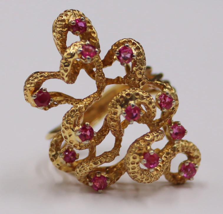 JEWELRY. Italian 18kt Gold and Colored Gem Ring.: Italian 18kt yellow gold modernist ring accented by (12) round pink faceted gems. Faceted gems measure approx. 2.5mm each. Stamped, "Italy 750 kt18" alongside a series of numbers. Total appr
