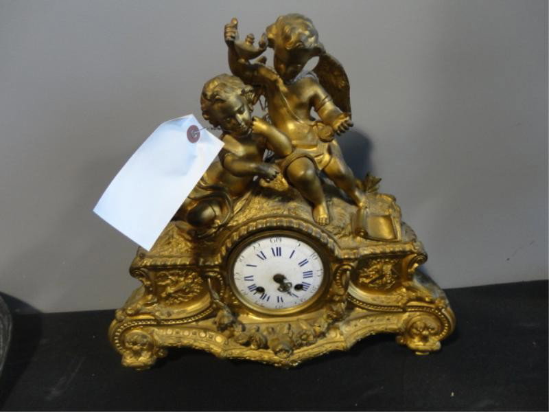 French Dore Bronze Clock with Putti.: From a NYC location. Dimensions: 14" wide x 13.5" high.