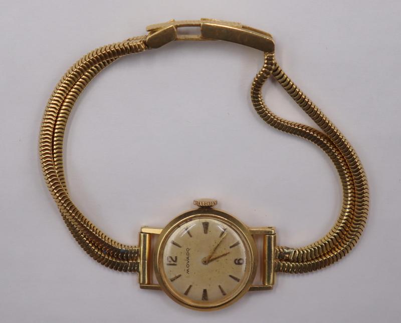 JEWELRY. Lady's Movado 18kt Yellow Gold Watch.: Watch. A ladies vintage Movado 18kt gold bracelet watch. This watch by Movado features an 20mm(excluding crown) Swiss made Movado signed 18kt yellow gold round watch case, acrylic crystal, silver tone
