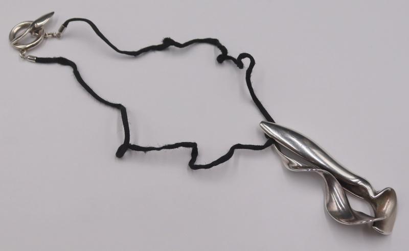 JEWELRY. Frank Gehry for T&Co. Sterling and Cord: Necklace. Frank Gehry for Tiffany & Co. sterling orchid pendant on black cord with a circular sterling toggle clasp. Pendant is inscribed, "Tiffany & Co © Gehry 925", and clasp