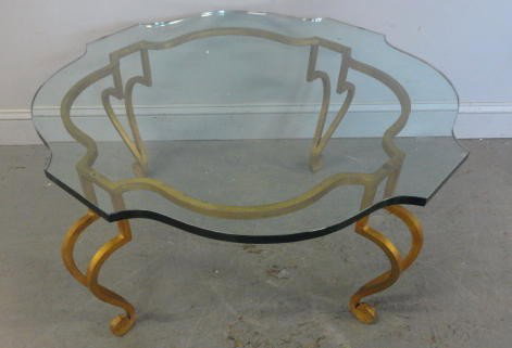 Gilt Metal and Glass Top Coffee Table.: Very decorative with nice gilding and thick shaped glass top. From a Forest Hills, Queens, NY estate. Dimensions: 36" x 18."