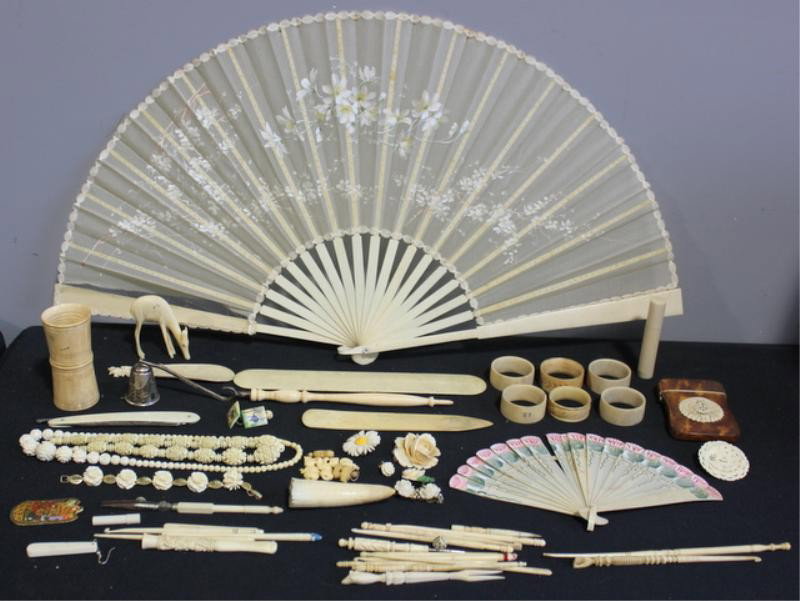 Ivory and Bone Lot Including TIFFANY.: Includes sterling and ivory snuffer marked Tiffany (12" long); a tortoise and ivory card case (2.5" x 3.75"); a tusk (3.25"); a cased ivory cigarette holder (3.5"); ivory and steel calipers?; corset b