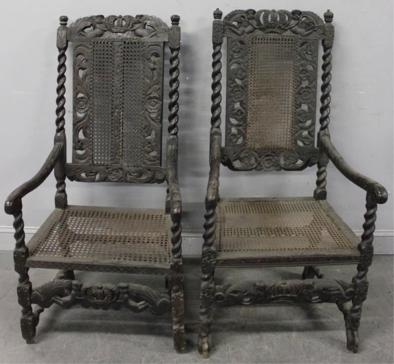 Pair of Caned and Carved Antique Continental Arm: Chairs. From a Long Island, NY location. Dimensions: 23" wide x 21" deep x 45" high.