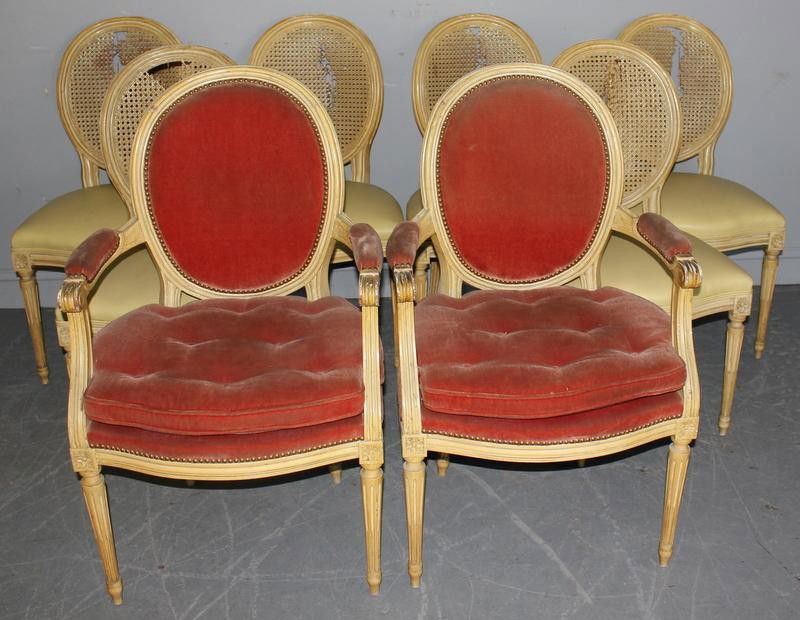 Set of 8 Vintage Louis XV Style Oval Back Dining: Chairs. Original yellow paint. From an 1100 Park Avenue NYC estate. Dimensions: Armchairs - 24" wide x 24" deep x 34.5" high. Sidechairs - 20.5" wide x 22" deep x 39" high. Condition: Cane backs as is