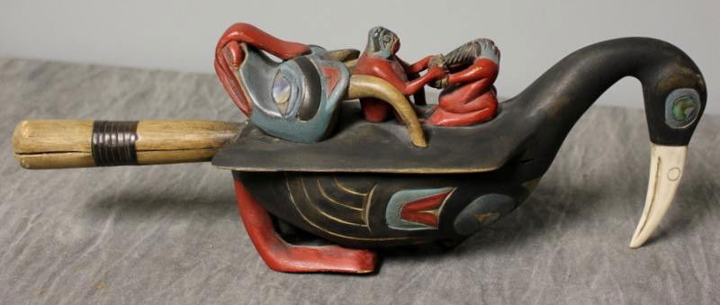 Northwest Coast Raven Rattle.: Painted and carved with abalone inlay and bone (?) beek. A copy, possibly from the 1970's. From a Bellmore, NY estate. Dimensions: 12" long.