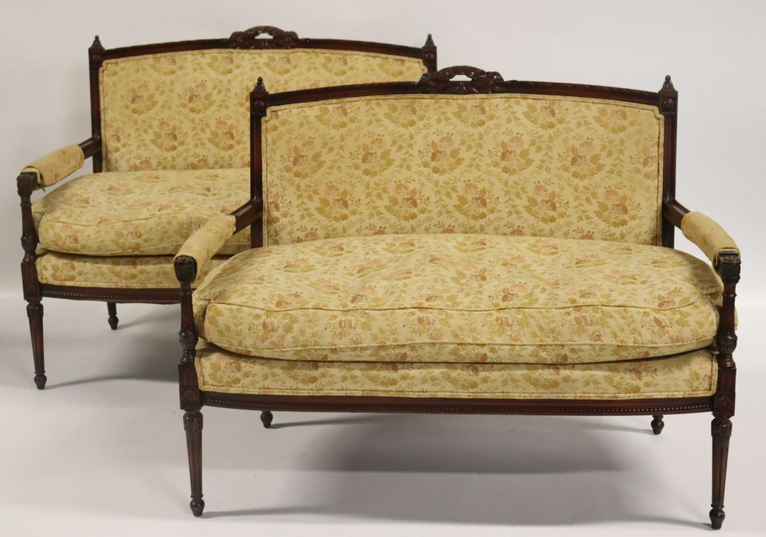 An Antique Pair Of Carved Louis XVI Style Settees: Great quality and down filled. From a Great Neck, Long Island, NY estate. - Dimensions: 36" h x 48" w x 23" d.