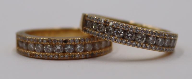 JEWELRY. Pair of 18kt Gold and Diamond Band Rings.: Includes a pair of 18kt yellow gold stacking band rings displaying central panels (12) round brilliant cut diamonds flanked by pave diamond accents. Total approx. weight of the two rings is 5.6 dwt (g