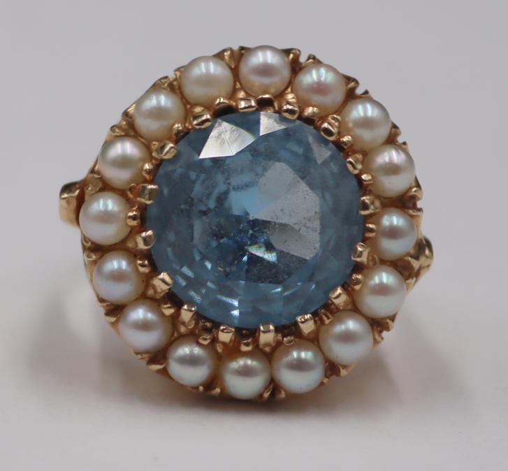JEWELRY. 14kt Gold, Colored Gem and Seed Pearl: Ring. 14kt yellow gold ring displaying a central round faceted blue gem with a surround of seed pearl accents. Stamped, "f 14K". Total approx. weight of the ring is 5.6 dwt (gross). Ring siz
