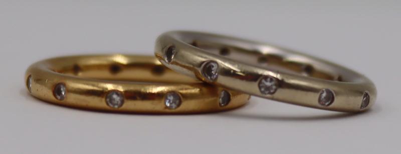JEWELRY. (2) 18kt Gold and Diamond Band Rings.: Includes (1) 18kt yellow gold band displaying (12) round full cut diamonds, and (1) 18kt white gold band displaying (12) round full cut diamonds. Each band is stamped, "18K". In the style of Tiffany &