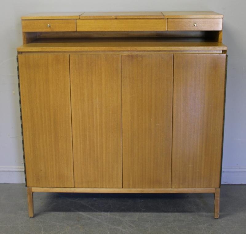 PAUL McCOBB Midcentury Dressing Cabinet.: Blonde finish. Fitted interior. From a 1170 Park Avenue NYC estate Dimensions: 48" wide x 19" deep x 50.5" high. Condition: Original finish with scuffs; old repair to back leg.