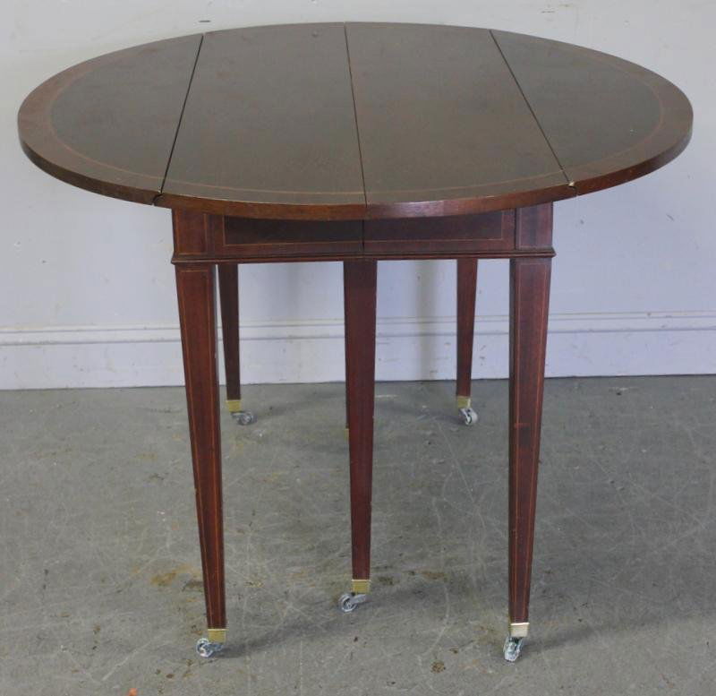 Custom Mahogany Banded and Inlaid Drop Leaf Dining: Table. With 3 leaves that have hinged skirts. From a Manhattan, NY collector. Dimensions: 45" wide x 41.125" deep x 30" high; leaves - 15.5" wide. Condition: Bumps and bruises; finish loss.