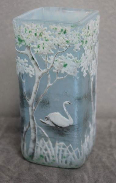 Daum Nancy French Cameo Cabinet Vase.: Depicting a lake scene of swimming swans. Signed "Daum Nancy." From a Larchmont, NY estate. Dimensions: 2.25" wide x 2.25" deep x 4.75" high. Condition: Small chip to one top corner; chip to one swan'