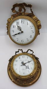 2 Bronze Wall Clocks As / Is.: Both clocks with battery replaced movements. The cases nice thick gilt bronze with ribbon crowns and enameled faces. 1 face signed Raingo Freres. From a Bedford, NY estate. - Dimensions: 11" h & 9" h.