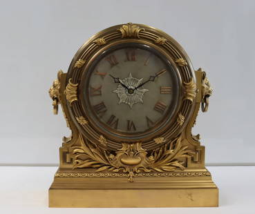 Vintage Gilt Bronze Electric Mantel Clock.: Good large size. Fine quality, heavy with foliate and Lion head decoration. From an Albertson, Long Island, NY estate. - Dimensions: 16.5" h x 15" w.