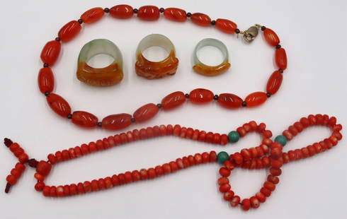 JEWELRY. Collection of Carved Chinese Jewelry.: Includes (3) assorted carved Chinese jade archer's rings with Russet skin; a coral beaded necklace with (3) turquoise bead accents; and a carved Carnelian beaded necklace with a sterling clasp. From a