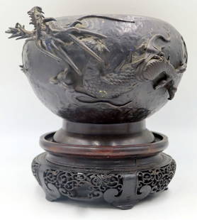 Japanese Bronze Planter with Dragon.: Japanese bronze planter displaying a high relief three-toed dragon clasping the flaming pearl within its claws. Accompanied by a carved wood stand. From a Bedford, NY estate. Dimensions: planter measu