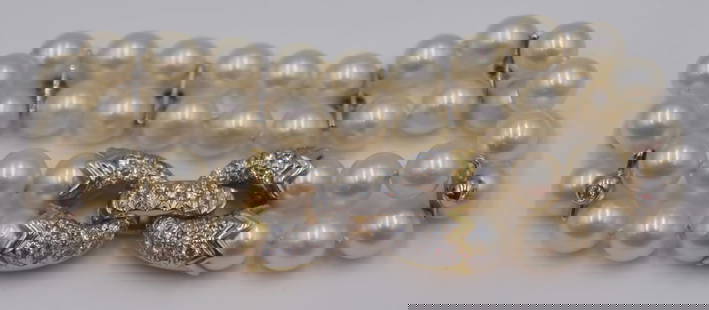JEWELRY. Cartier 18kt Bi-color Gold, Pearl and: Diamond Bracelet. Signed Cartier double strand pearl bracelet with an 18kt bi-color gold clasp inlaid throughout with pave diamonds and further accented by (6) 18kt white gold spacers displaying singl
